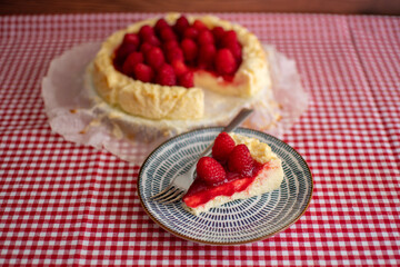 Delicious slice of cheesecake decorating with raspberries