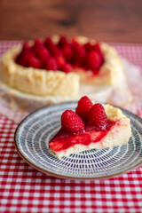 Delicious slice of cheesecake decorating with raspberries