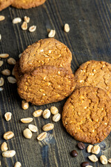 oatmeal cookies with peanuts on a black wooden table