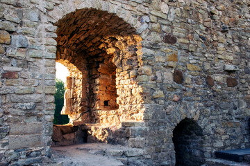 Stone walls and window openings of the ancient city. Stone ruins.