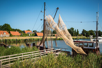 Enkhuizen, Netherlands, June 2022. Traditional fishing boats and nets hanging out to dry at the...