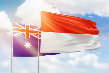 Sunny blue sky and flags of indonesia and australia