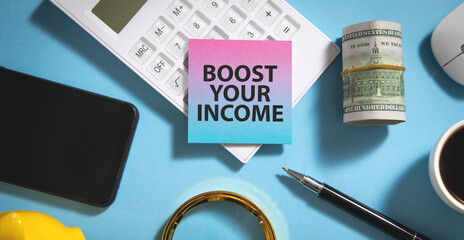 Boost Your Income text on sticky note with a business objects.