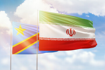Sunny blue sky and flags of iran and dr congo