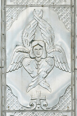 Ancient metal icon of seraphim, on the facade of the old church.