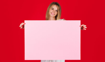 Smiling girl with empty advertising banner. Beautiful woman with blank billboard. Discount. Sales.