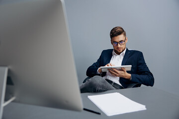 businessmen wearing glasses works in front of a computer isolated background