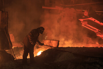Man works in blast furnace area workshop.