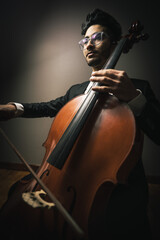 Classic cello player performing with suit
