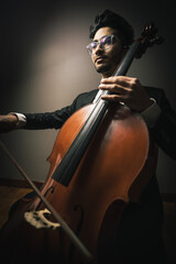Classic cello player performing with suit © federico
