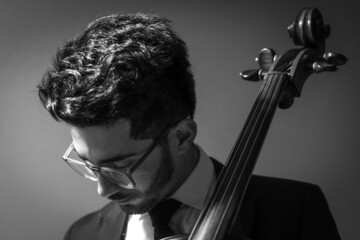 Classic cello player performing with suit