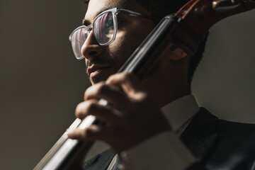 Classic cello player performing with suit