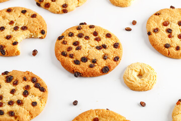 Chocolate american cookies with chocolate chips and raisins on white wooden table. Top view, flat lay.