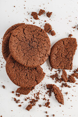 Chocolate american cookies with chocolate chips and raisins on white wooden table. Top view, flat lay.