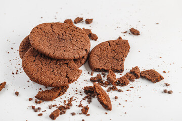 Chocolate american cookies with chocolate chips and raisins on white wooden table. Top view, flat lay.