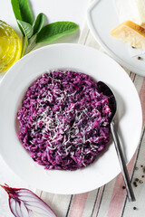 Italian risotto with blueberries and red onions with cheese and sage on the table