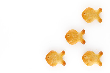 Yellow fish crackers on isolated white background. Close-up.