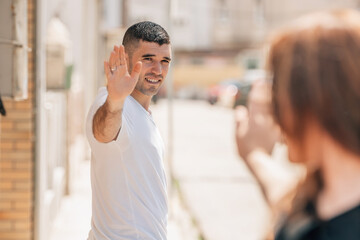 young people greeting or saying goodbye in the city street