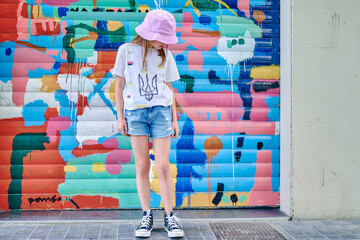 girl in pink panama on a colored wall background