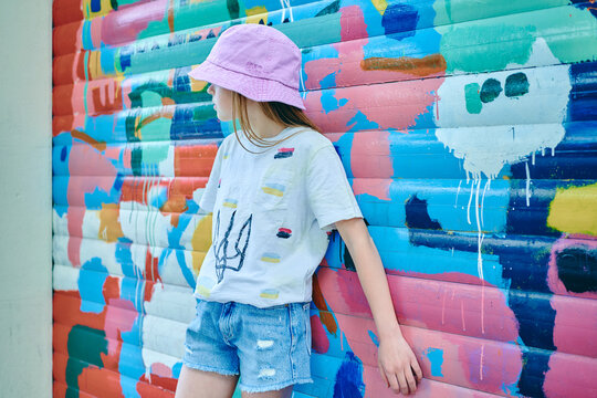 girl in pink panama on a colored wall