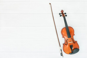 Fototapeta na wymiar Violin and bow on white wood background.