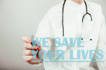 Female doctor writing text we save your lives. Healthcare, saving life, medical concept