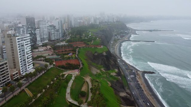 Aerial drone footage of cloudy Lima coastline with ocean and buildings view. Miraflores, Lima, Peru.