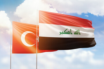 Sunny blue sky and flags of iraq and turkey