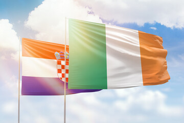 Sunny blue sky and flags of ireland and croatia