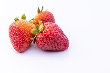Three strawberries on white