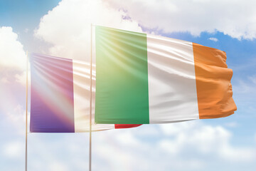 Sunny blue sky and flags of ireland and france