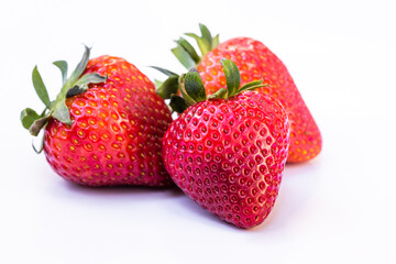 Three strawberries on white