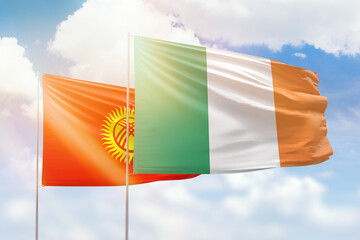 Sunny blue sky and flags of ireland and kyrgyzstan