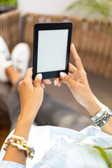 young woman laying down while reading with an e-book