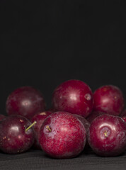 Fototapeta na wymiar plums with black background