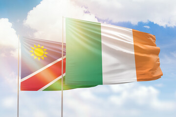 Sunny blue sky and flags of ireland and namibia
