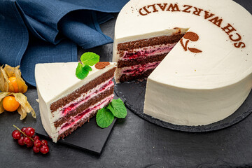 Chocolate sponge cake with cherries and white cream. Schwarzwald.