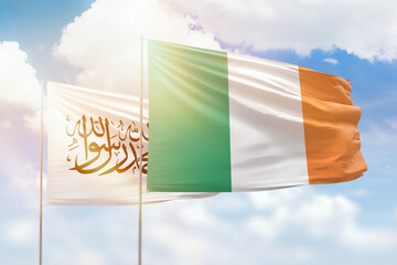 Sunny blue sky and flags of ireland and afghanistan