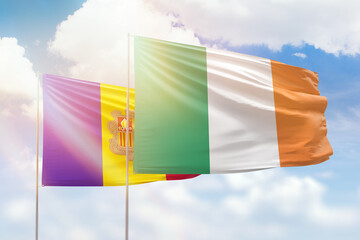 Sunny blue sky and flags of ireland and andorra