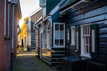 Walking on sunny day in small Dutch town Marken with wooden houses located on former island in North Holland, Netherlands