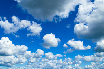 Beautiful summer blue sky. Fluffy white cumulus clouds.