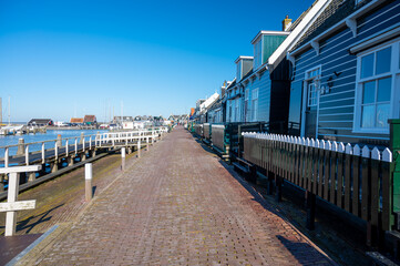 Walking on sunny day in small Dutch town Marken with wooden houses located on former island in North Holland, Netherlands