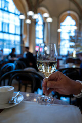 Lifestyle of beautiful Vienna, glass of white dry Austrian wine served in old Viennese-style cafe in Vienna, Austria