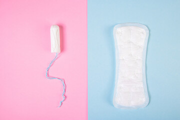 Sanitary pad and tampon on colored background. Feminine hygiene products. Menstruation concept.