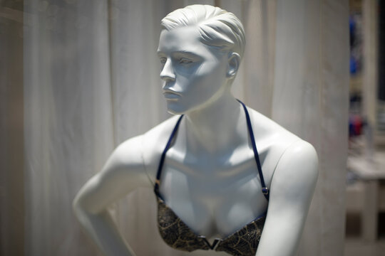 Women's mannequin in clothing store. Plastic figure of woman. Store details. Demonstration of clothes.