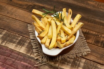 Tasty french fries on plate on bowl
