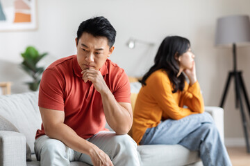 Sad asian man fighting with his lover, home interior