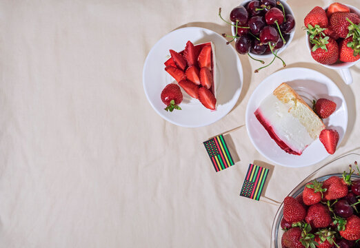 Juneteenth Day Picnic Background With Black Liberation African American Flags, Sweet Salad With Cherries And Strawberries, Strawberry Cheesecake