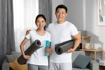 Positive asian couple going to gym together