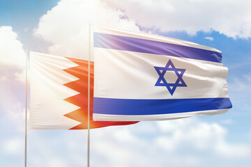 Sunny blue sky and flags of israel and bahrain